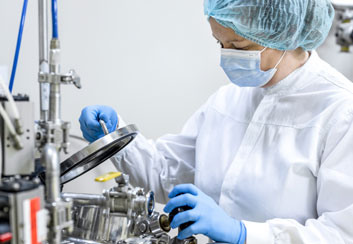 A female scientist using medical tools while experimenting 