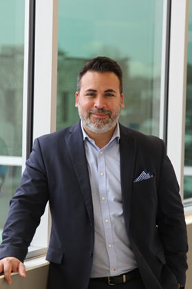 David Grégoire, Vice President of Compliance and Regulatory Affairs for Altasciences, smiling while standing in front of a window.